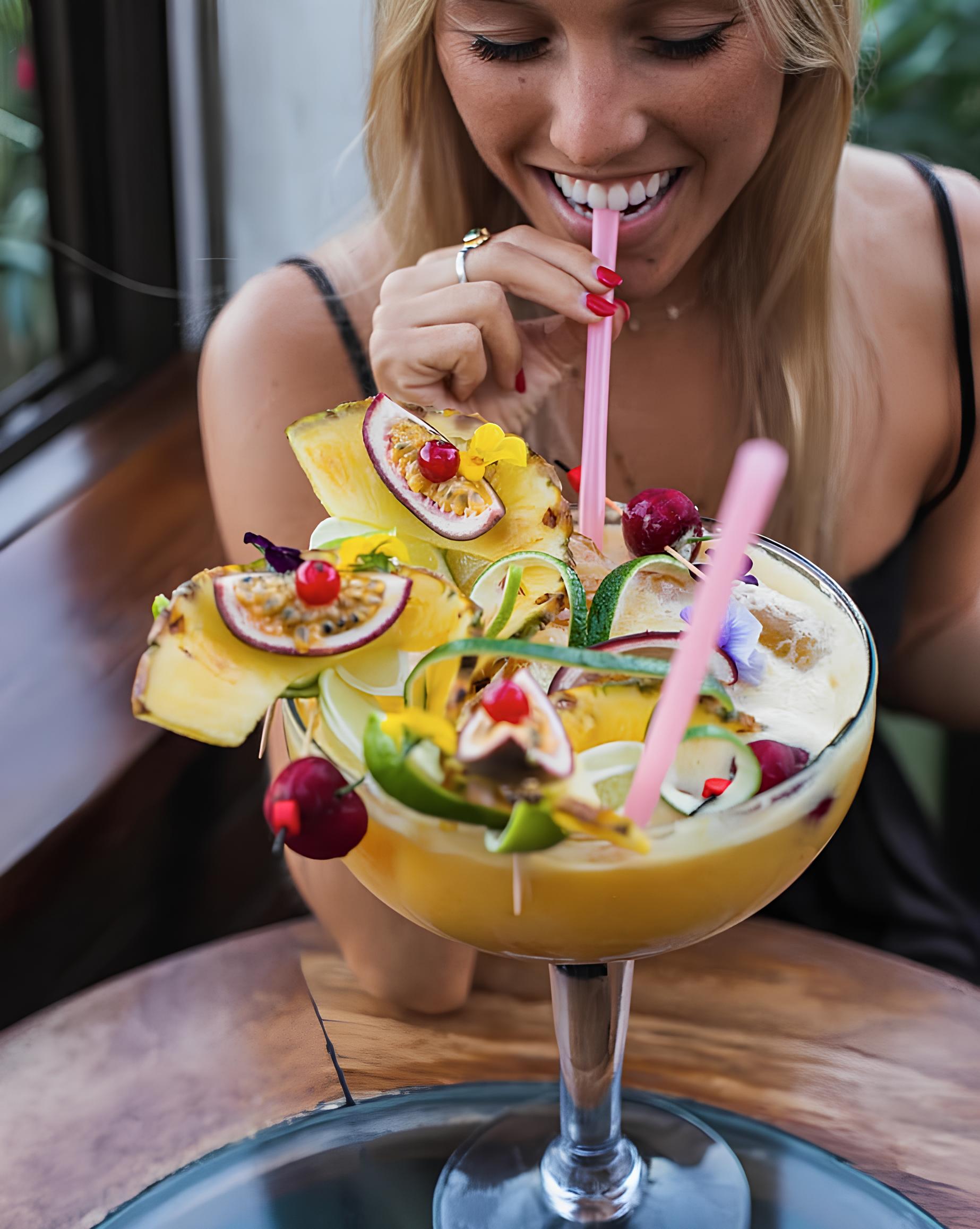 Woman enjoying a cocktail on the terrace at Astral Bar