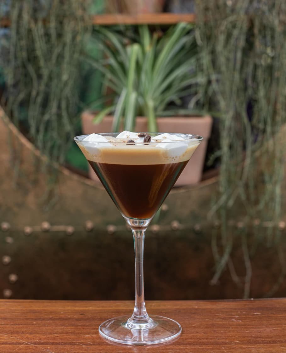 Elegant cocktail presentation with tropical garnish at Astral Bar Puerto Banús